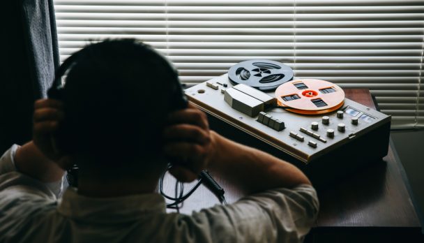 Special,Agent,Listens,On,The,Reel,Tape,Recorder.,Officer,Wiretapping