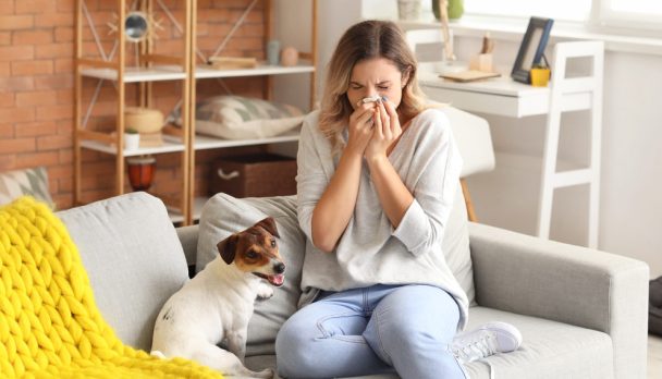 Young,Woman,Suffering,From,Pet,Allergy,At,Home