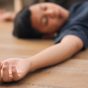 Closeup,Hand,Of,Unconscious,Kid,Lying,On,The,Floor,At
